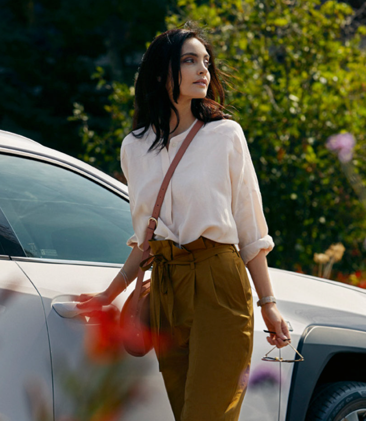 Eine Frau öffnet die Tür eines Lexus NX