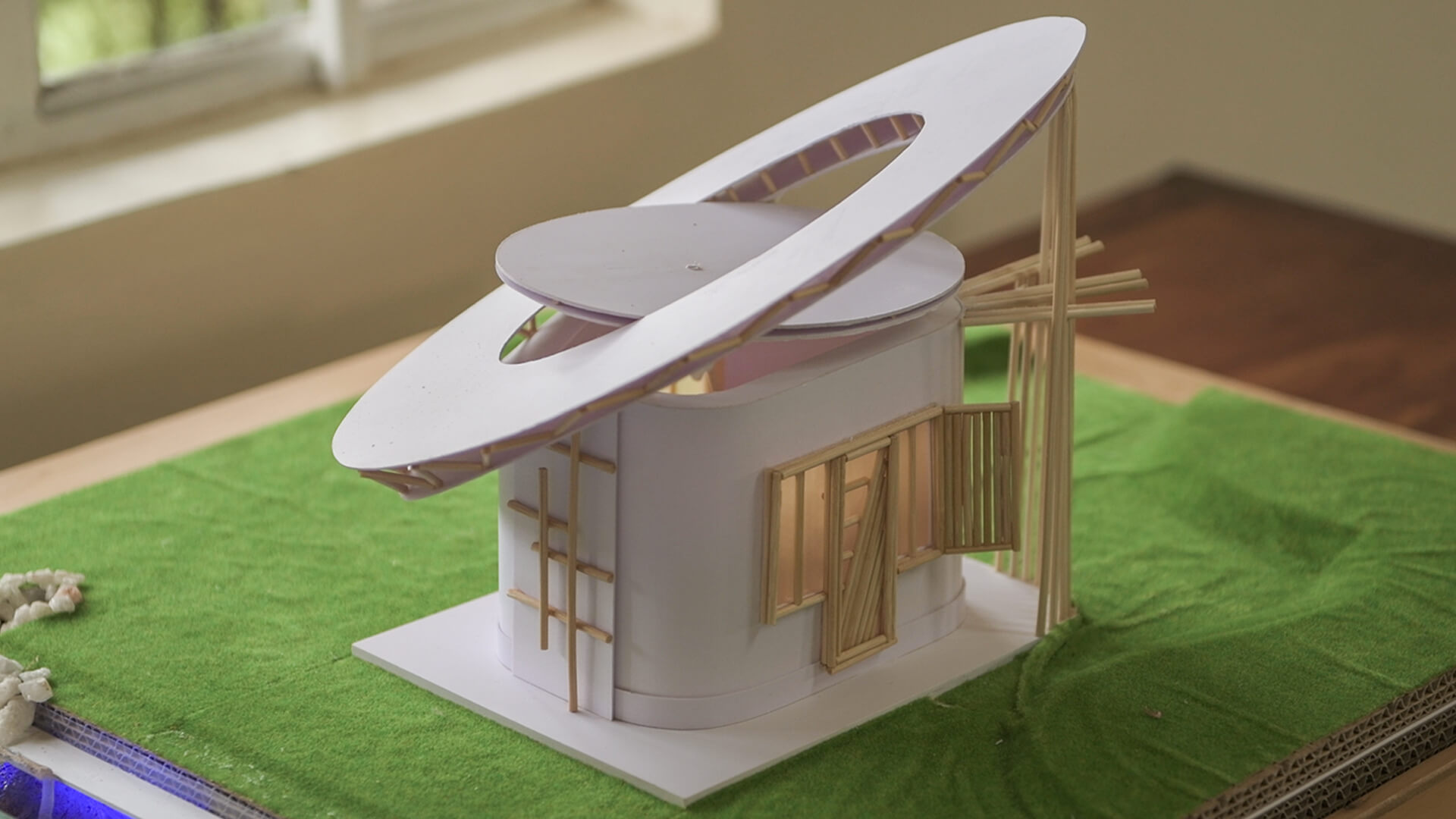 Ein Modernes Miniatur Haus mit mehreren Bambusstäbchen