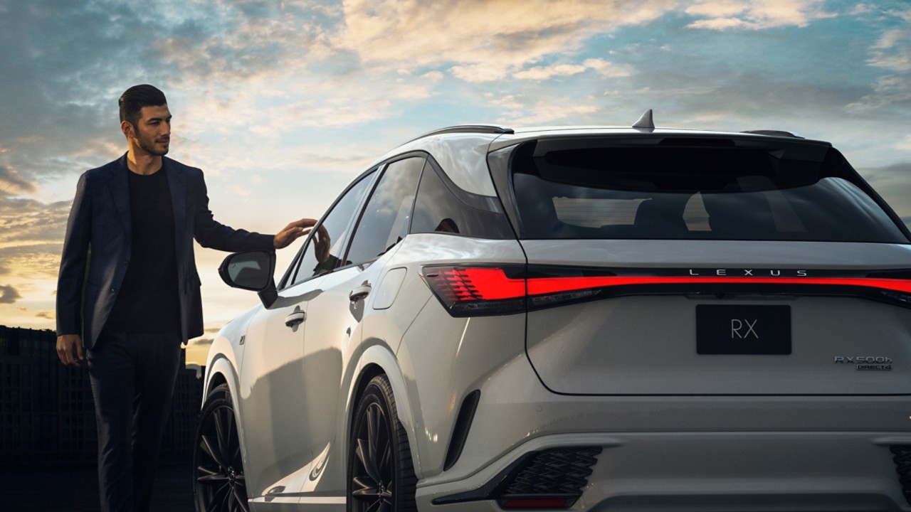 Mann steht vor grauen Lexus RX