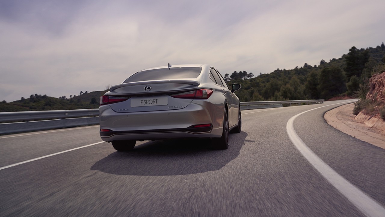 Rear view of the Lexus ES driving on a road