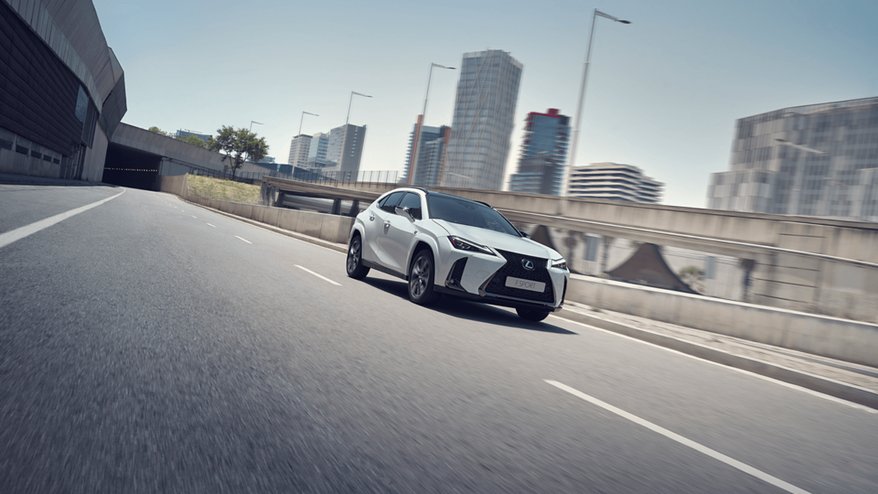  A Lexus UX driving through an urban area