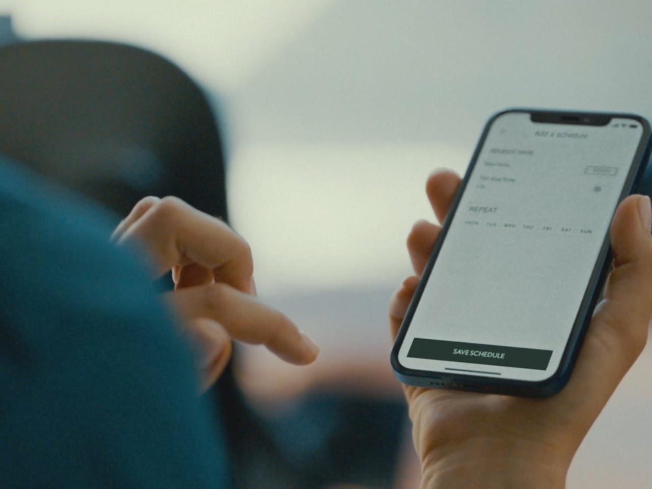 A person using a mobile phone to access the Lexus Link app